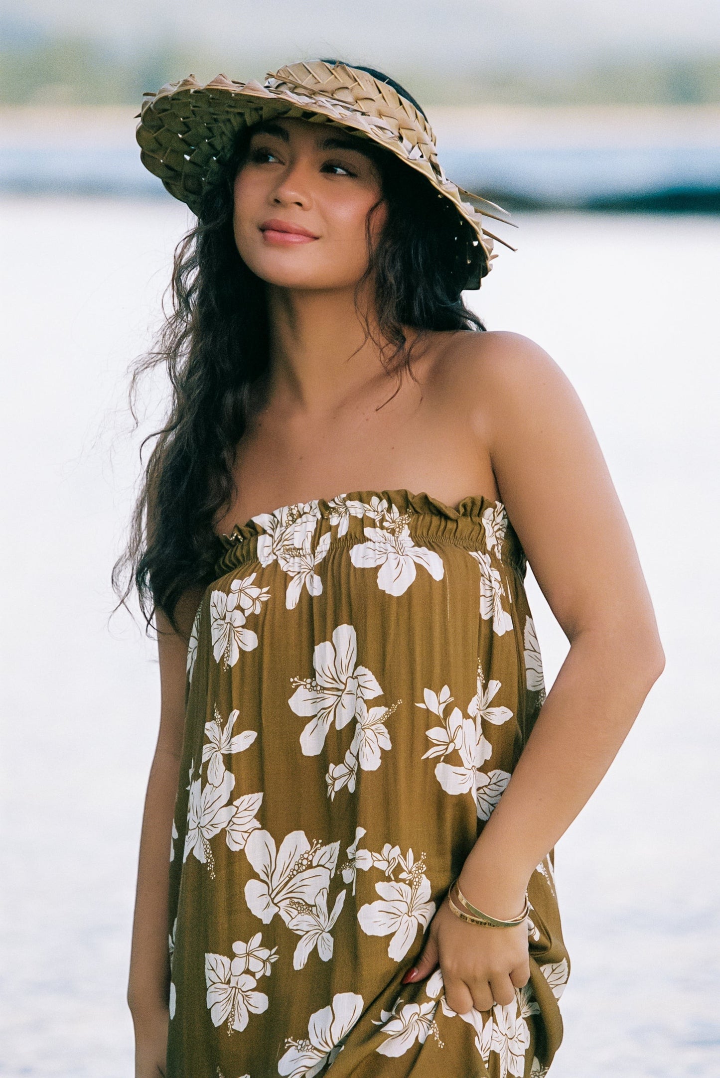 Guava Jammies Mahealani Midi Dress in olive green with white floral print. Strapless, elastic top, high-low hem.