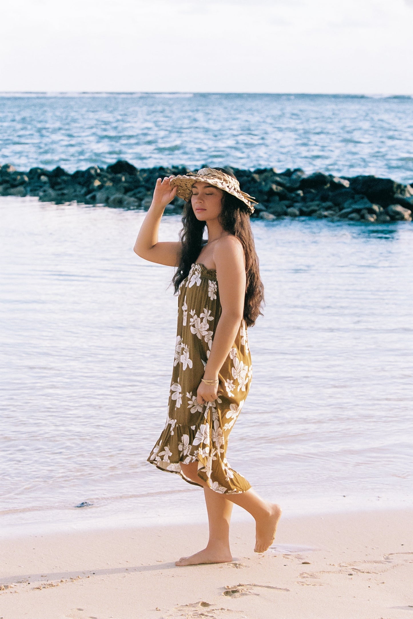 Guava Jammies Mahealani Midi Dress in olive green with white floral print, strapless, high-low hem, rayon voile.