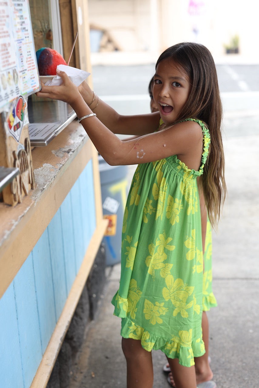 Guava Jammies Mahealani Mini Dress in lime green with yellow floral print, ruffled hem and straps.